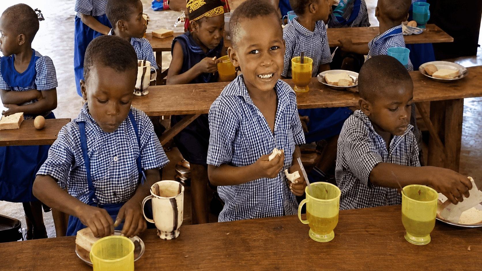 Children sharing a meal of bread, eggs and milk at a Noela4kids partner school