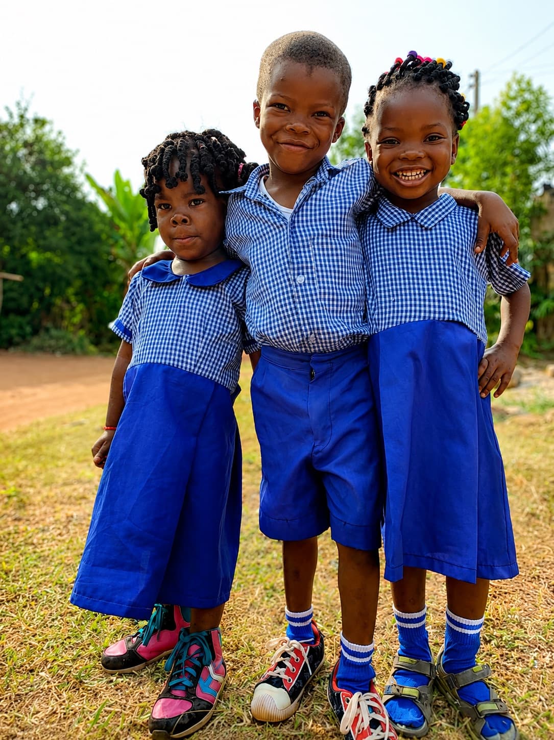 Three nursery school children in uniform at a Noela4kids partner school in Nigeria